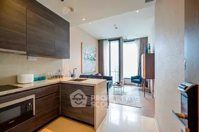 Modern open-layout kitchen leading to a stylish living room with natural light.