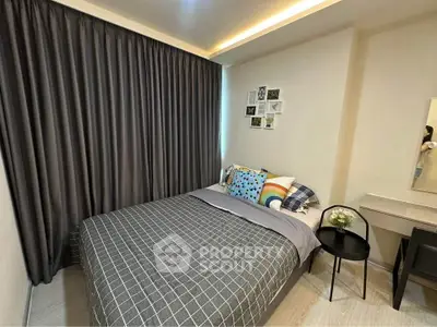 Cozy bedroom with modern decor and stylish bedding in a well-lit apartment.