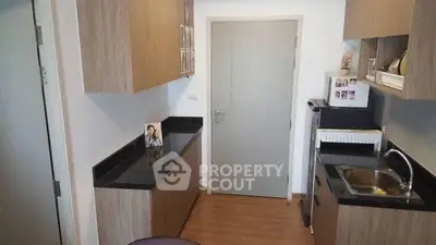 Compact kitchen with modern cabinetry and sleek countertops