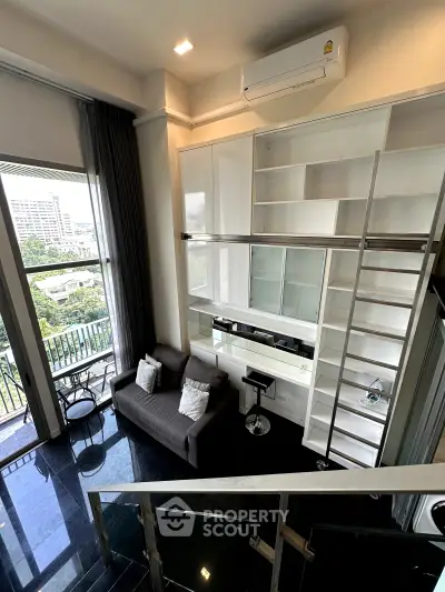 Modern loft apartment with high ceilings, large windows, and stylish mezzanine overlooking city view.