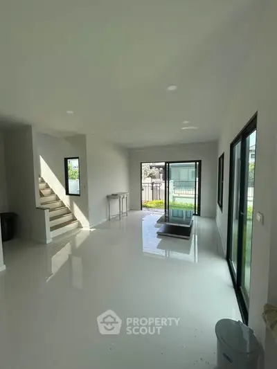 Spacious modern living room with large windows and garden view