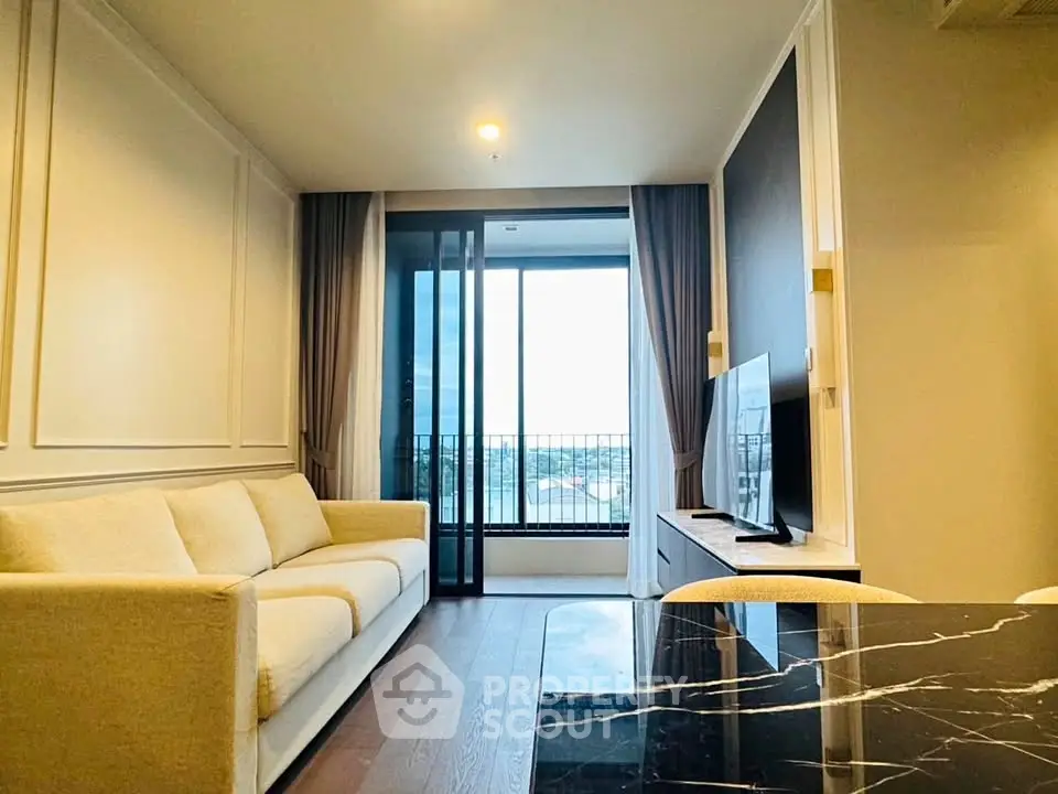 Modern living room with elegant decor and large window offering a stunning view.