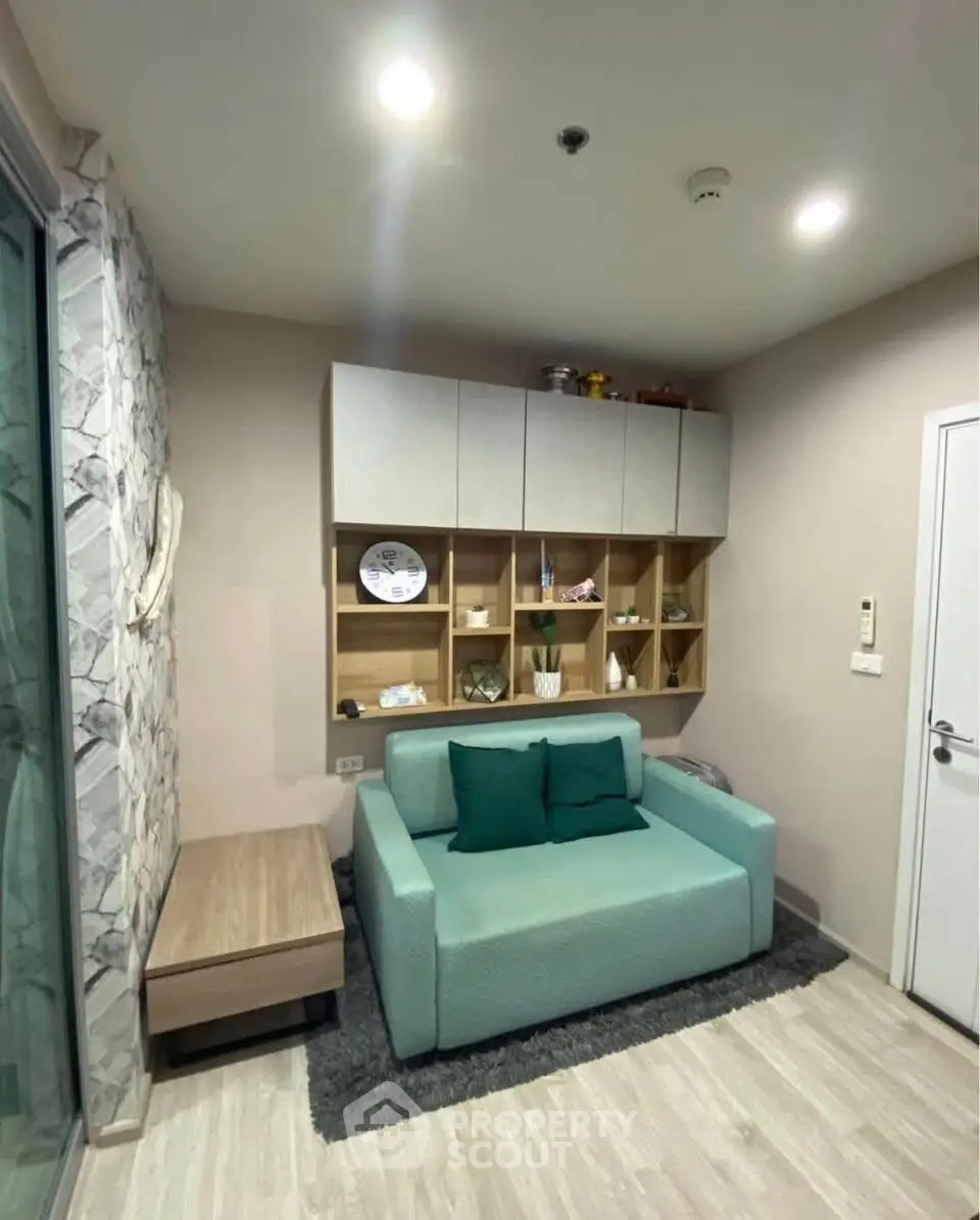 Modern living room with stylish sofa and wall-mounted shelves in cozy apartment.