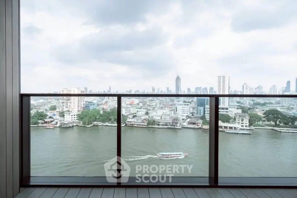 Stunning river view from a modern balcony in a high-rise apartment with city skyline.