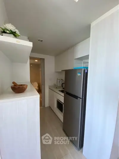 Modern compact kitchen with sleek appliances and minimalist design