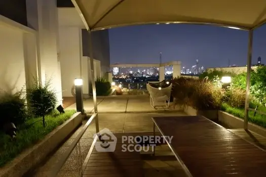 Stunning rooftop terrace with city skyline view at night, perfect for entertaining.