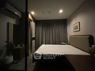 Cozy bedroom with modern decor and ambient lighting, featuring a comfortable bed and stylish curtains.