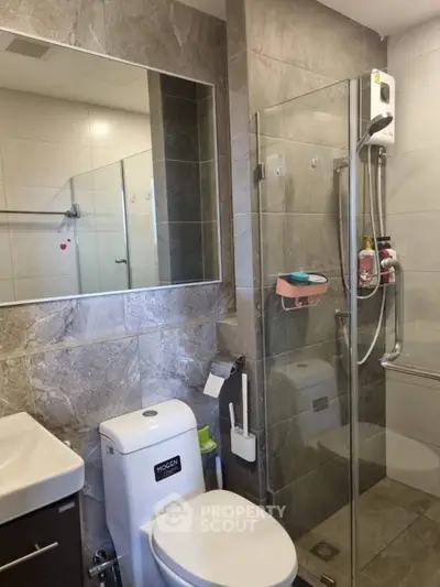 Modern bathroom with glass shower enclosure and sleek fixtures