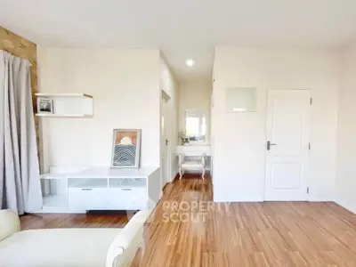 Spacious and bright living room with modern decor and wooden flooring