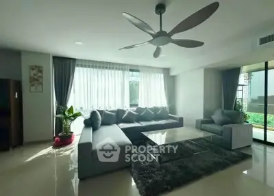 Spacious modern living room with large windows and stylish decor