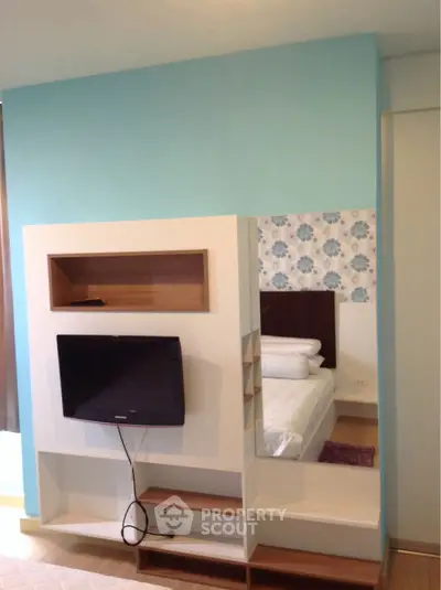 Modern bedroom with stylish TV setup and elegant decor