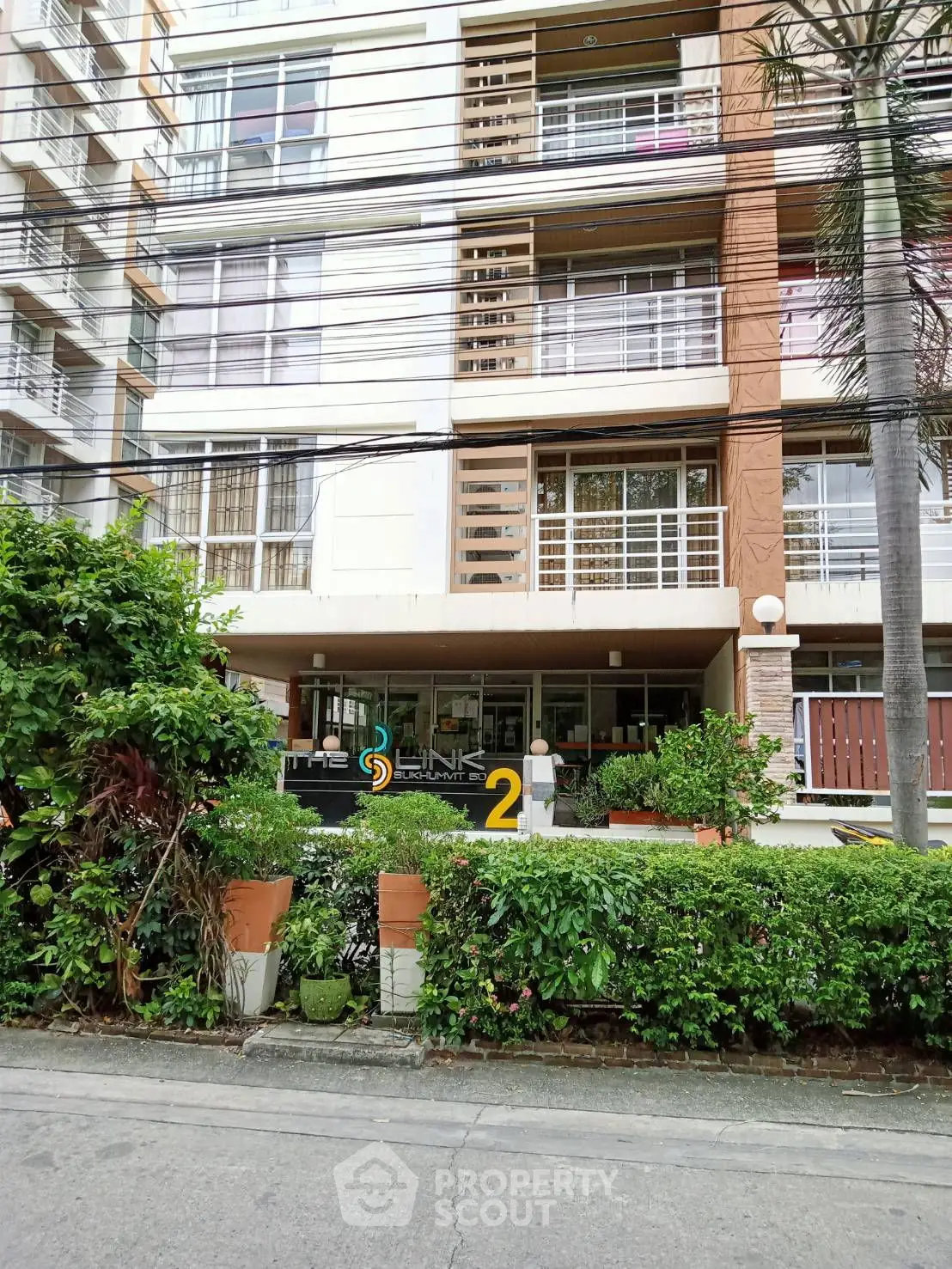 Distorted image of a modern building with greenery in front.