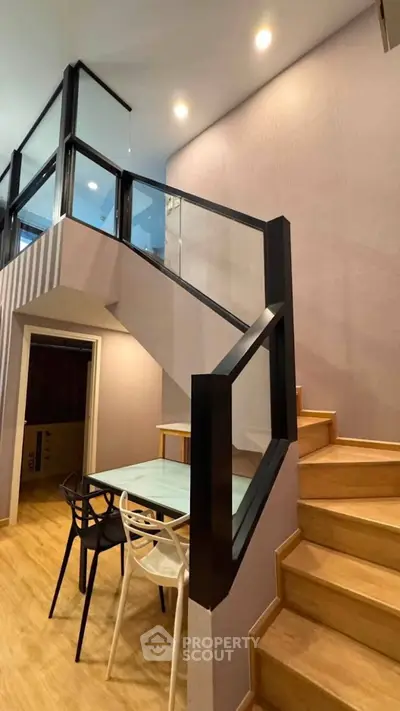 Modern duplex interior with stylish staircase and dining area