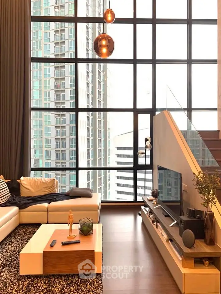 Luxurious modern living room with floor-to-ceiling windows and stylish decor