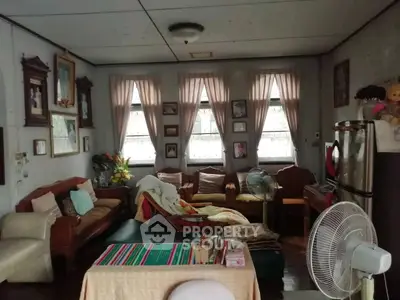 Charming vintage living room with classic furniture and decor, featuring cozy seating and natural light.