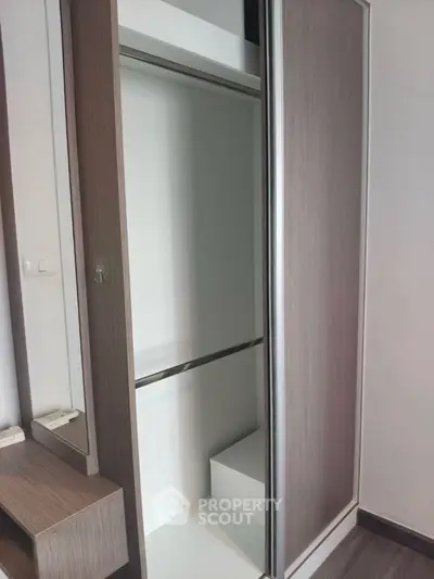 Modern built-in wardrobe with sleek sliding doors in a stylish interior.