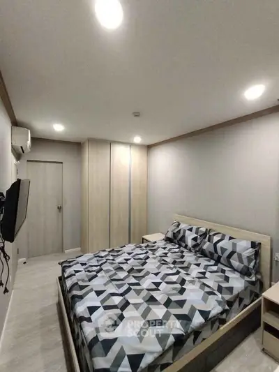 Modern bedroom with geometric bedding and sleek wardrobe design