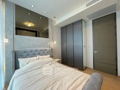 Modern bedroom with elegant design, featuring a plush bed and sleek wardrobe.