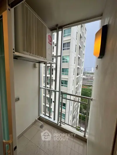 Compact balcony with city view in modern high-rise apartment