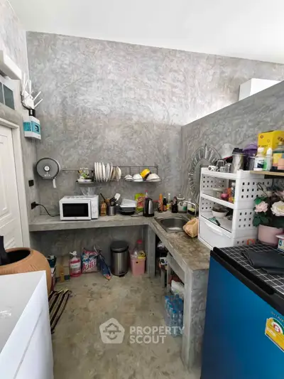 Cozy kitchen with open shelving and modern appliances in a compact layout.