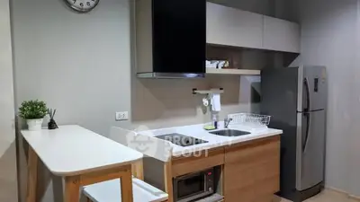 Modern kitchen with sleek appliances and stylish dining area