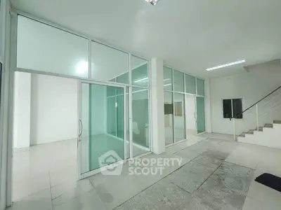 Spacious modern office space with glass partitions and tiled flooring, ideal for businesses seeking a sleek environment.