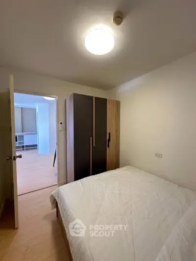 Cozy bedroom with modern wardrobe and soft lighting in a stylish apartment
