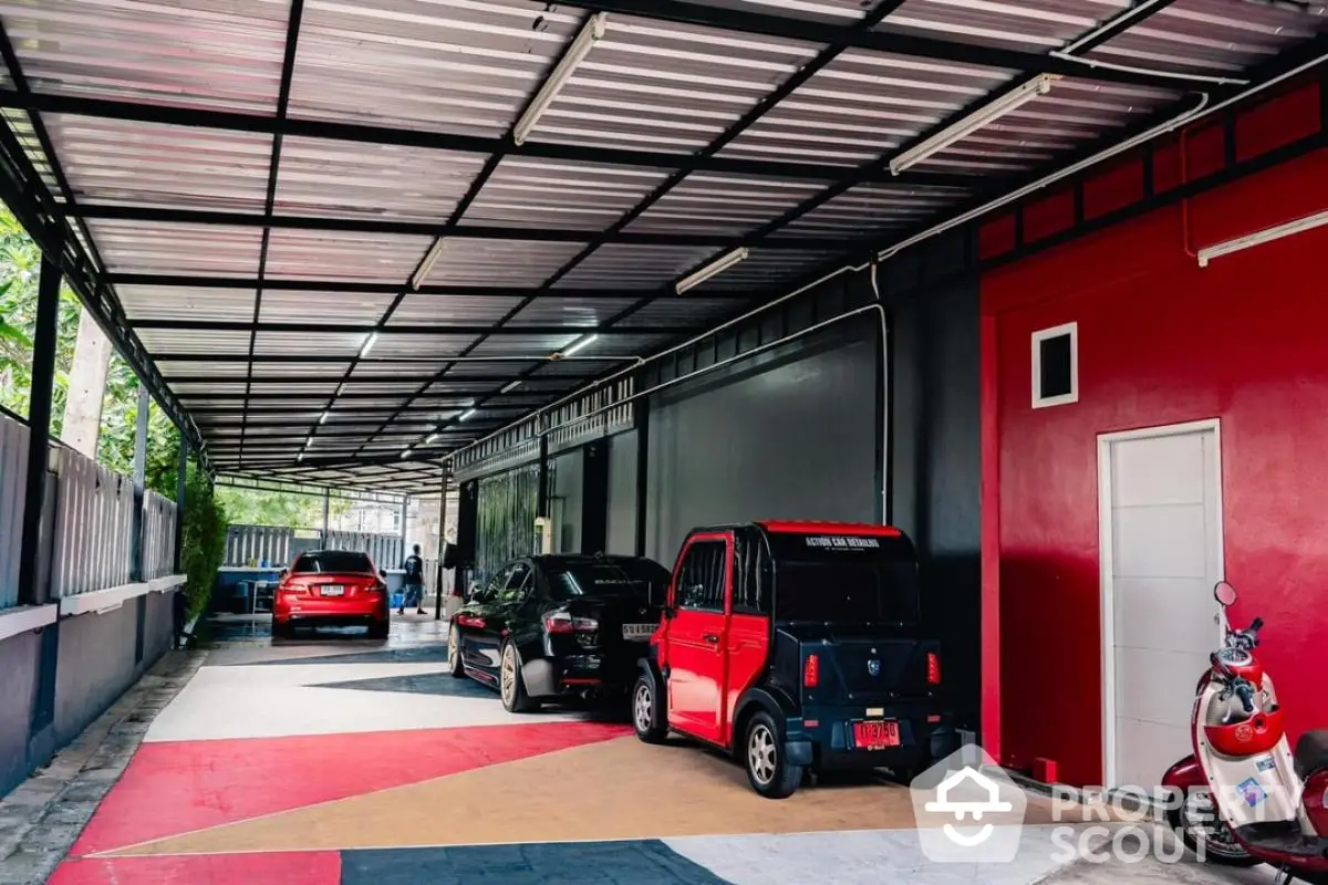 Spacious covered parking area with modern design and multiple vehicles parked.