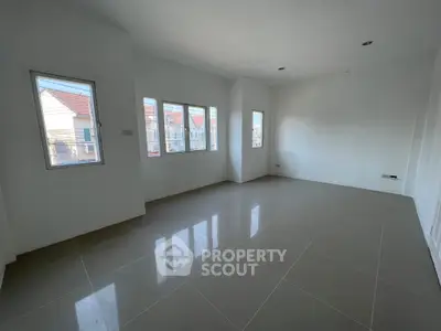 Spacious empty room with large windows and glossy tiled floor, perfect for customization.