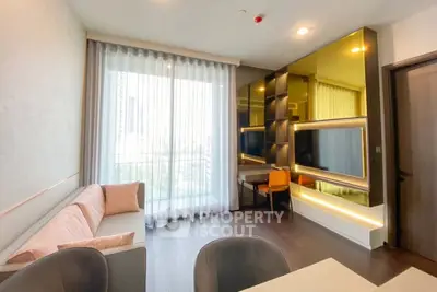 Modern living room with floor-to-ceiling windows and stylish decor in a high-rise apartment.