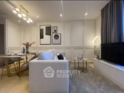 Modern living room with elegant decor and dining area, featuring stylish lighting and cozy ambiance.
