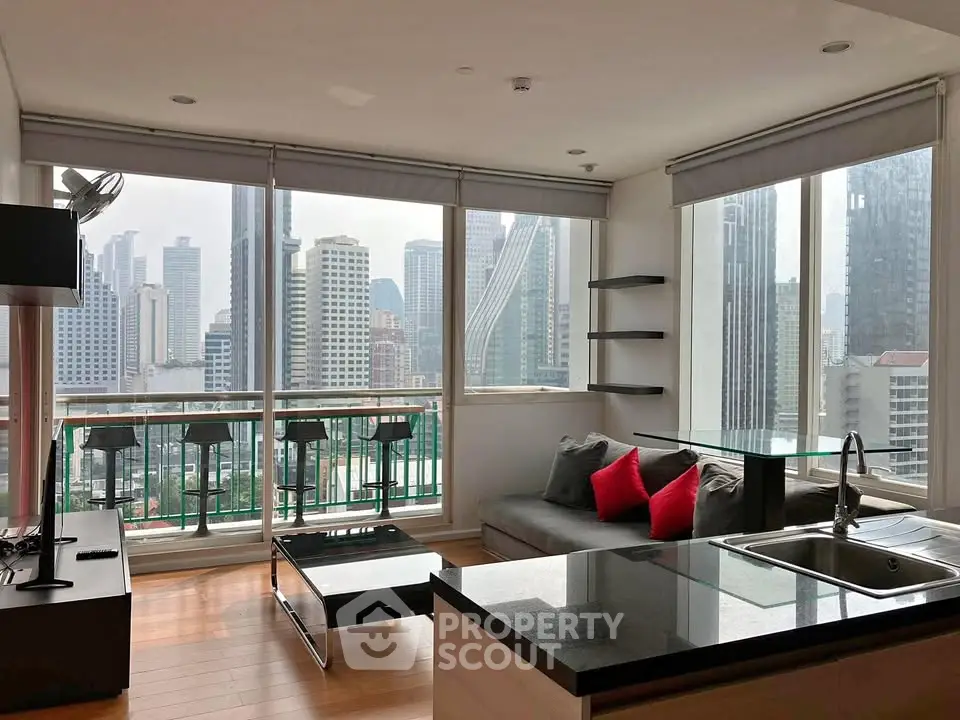 Modern living room with stunning city view, open kitchen layout, and stylish decor in high-rise apartment.