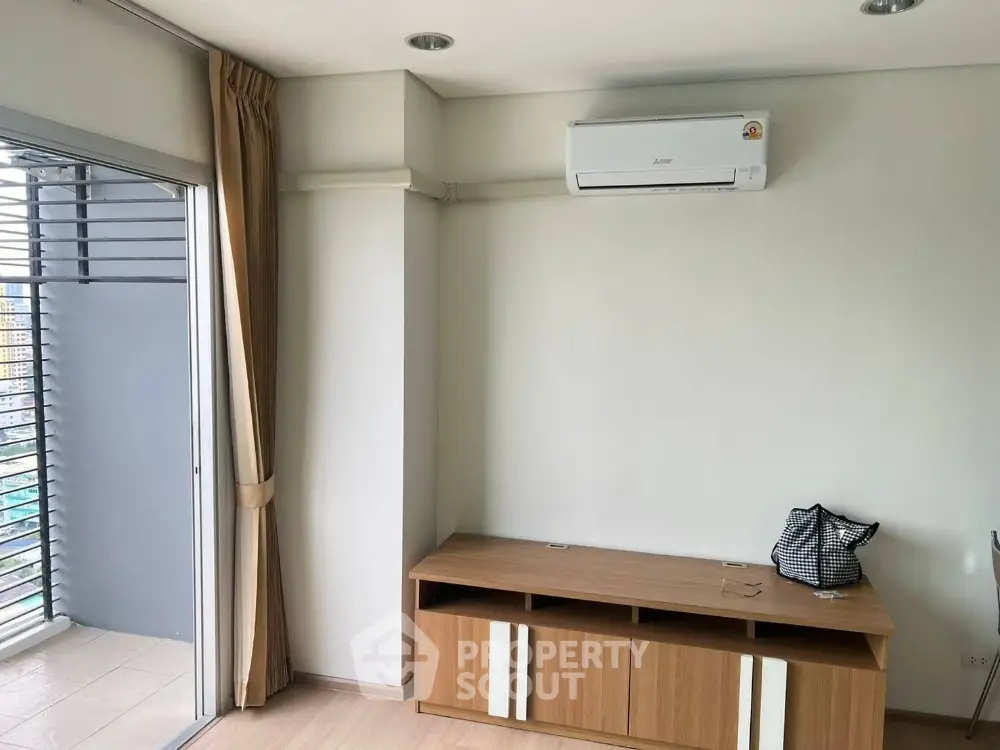 Modern apartment interior with air conditioning and balcony view