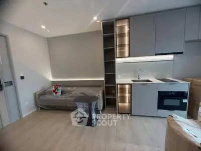Modern studio apartment with sleek kitchen and cozy living area