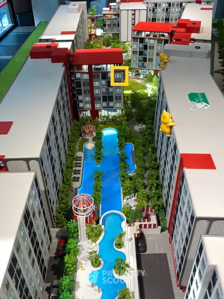Stunning architectural model showcasing modern residential complex with lush greenery and inviting pool area.