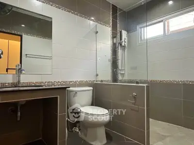 Modern bathroom with glass shower and sleek tile design
