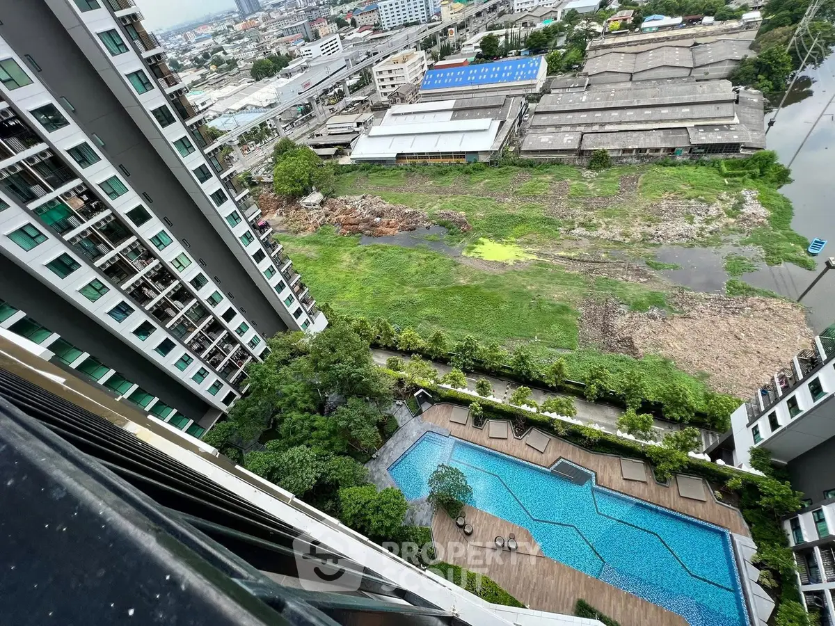 High-rise building with pool and cityscape view from balcony