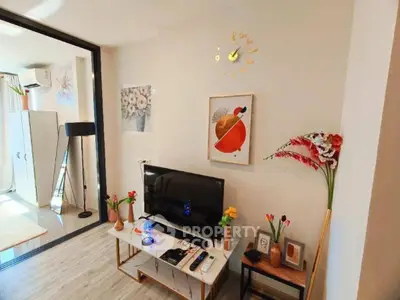 Charming living room with modern decor and wall art, featuring a sleek TV setup and vibrant floral accents.