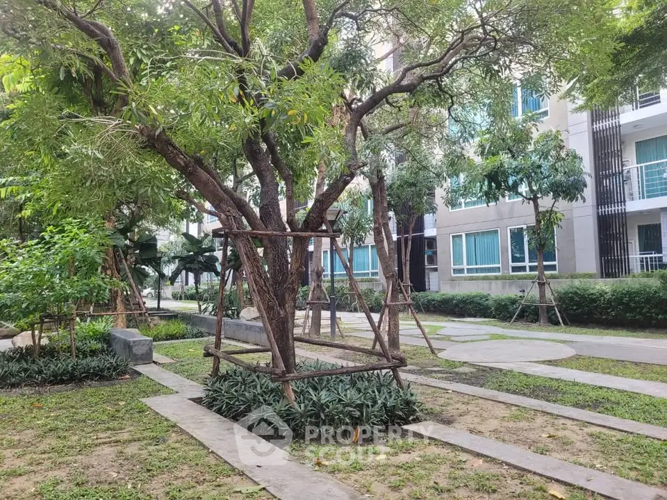 Lush garden area with mature trees in a modern residential complex
