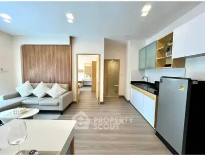 Modern open-layout living room with sleek kitchen and stylish decor