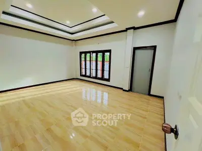 Spacious empty room with elegant ceiling design and large windows, perfect for customization.