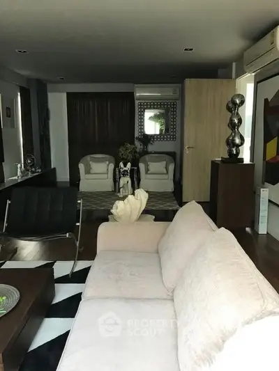 Elegant living room with modern decor and plush seating in a stylish apartment.