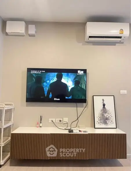 Modern living room with wall-mounted TV and air conditioning unit