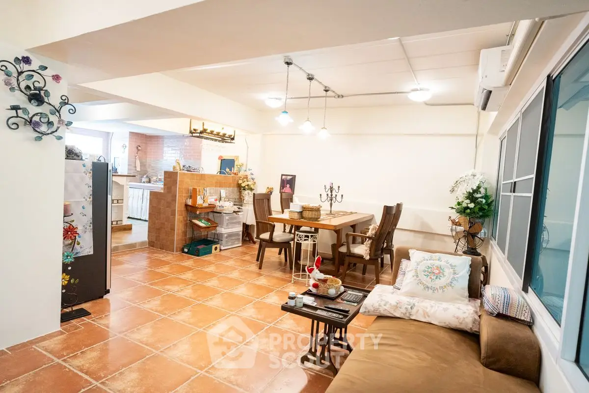 Charming open-concept living and dining area with cozy decor and warm lighting.