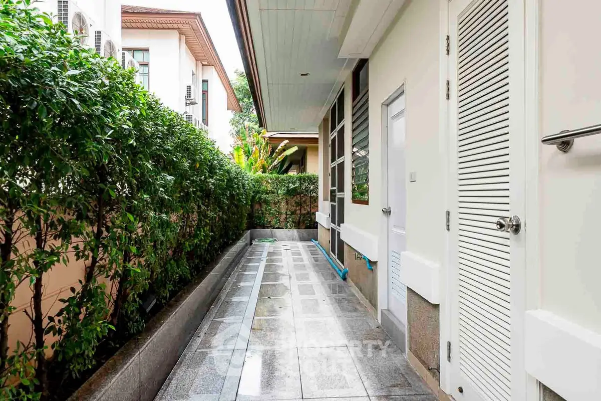 Charming exterior walkway with lush greenery and modern design