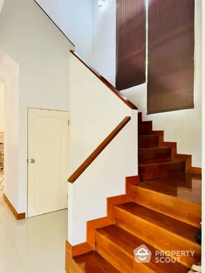 Elegant wooden staircase with modern design and natural lighting