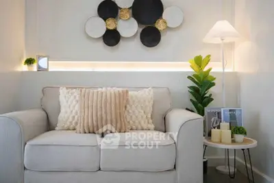 Chic living room with modern decor and cozy seating in a stylish apartment.