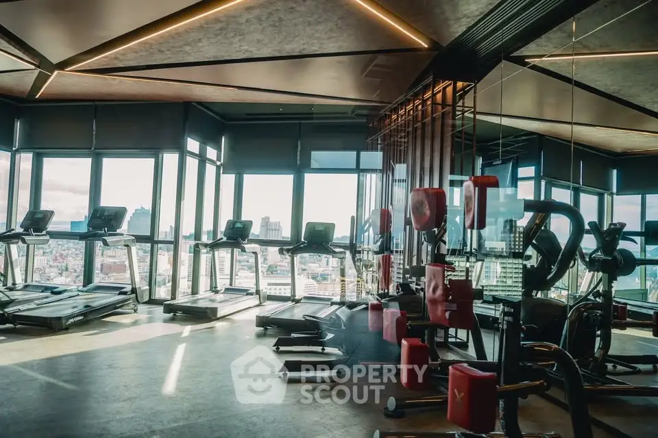 Luxurious high-rise gym with panoramic city views and modern fitness equipment.