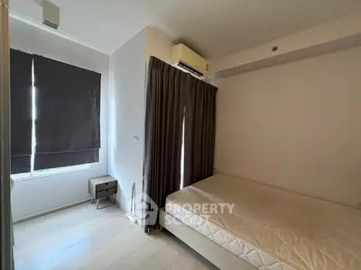 Cozy bedroom with air conditioning and natural light, perfect for restful nights.