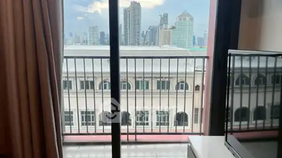 Stunning city view from a modern apartment balcony with sleek railing.